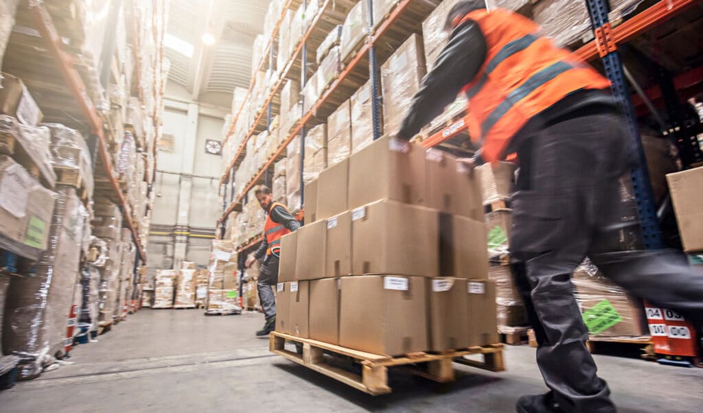 Men moving a pallet of boxes in a warehouse