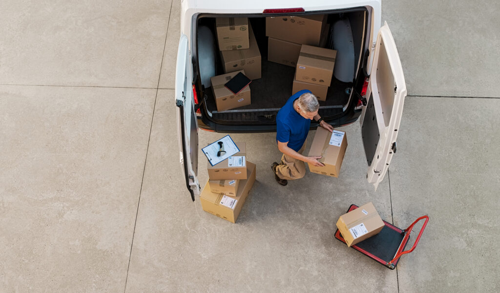 Man unloading boxes from van