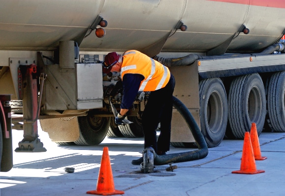 A carrier work preps the fuel intake.